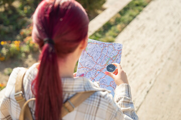 Tourist with compass and map in the city