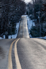 Solomons, Maryland, USA A hilly two lane country road in the snow.