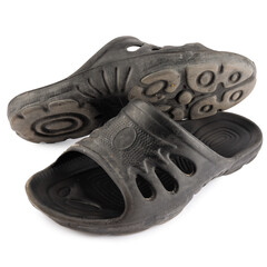 old and dirty men's flip-flops in black on a white background