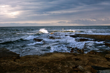 The serene beauty of the Moray Firth's rocky coastline in Scotland