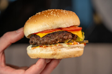 Close-up of a juicy cheeseburger in a restaurant