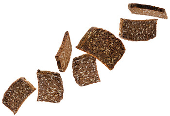 Sliced dark bread with sunflower seeds fly in space forming a chain shape. Volumetric back light. Isolated on white