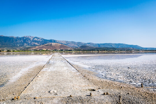 Tigkaki Salt pan, salt lake in Tigaki village with view of Dikeos mountain in the background, Kos island, Greece