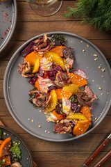 Portion of gourmet beef with pumpkin and beets on wooden table