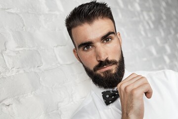 Thoughtful young bearded man portrait photo with copyspace.