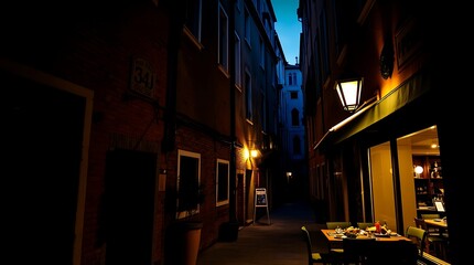 Dark, narrow alleyway at night with restaurant.