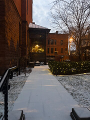 Snowy backyard walkway with christmas lights