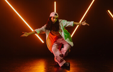 Hip hop dancer dancing in a cool studio with neon lights.