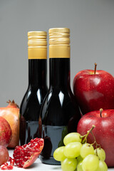 Vinegars in glass bottles among fruits