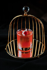 red cocktail with foam decorated with a flower top view