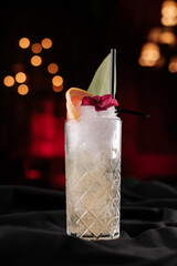 tropical grapefruit cocktail on black table in night club