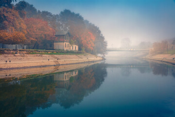 Fototapeta premium Foggy morning view of popular tourist attraction - Regi csonakhaz. Marvelous autumn cityscape of Gyor town, capital of Gyor-Moson-Sopron County and Western Transdanubia region, Hungary, Europe.