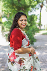 Beautiful Indian female, Beautiful portrait of young woman standing in nature wearing traditional clothing sarry  - stock photo