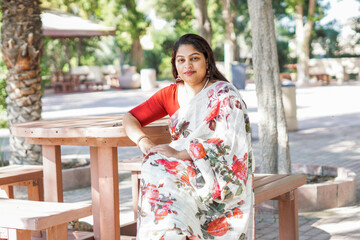 Beautiful Indian female, Beautiful portrait of young woman standing in nature wearing traditional clothing sarry  - stock photo