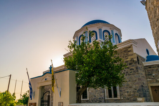 Sunset sky with traditional blue dome church on Kos island, Greece