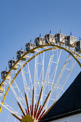 A large Ferris wheel with a yellow and white color scheme
