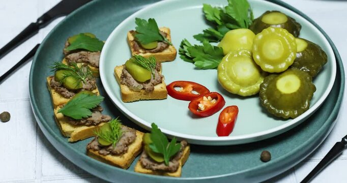 Exquisite appetizers, pate on toast, marinated pattypan squash, and fresh herbs