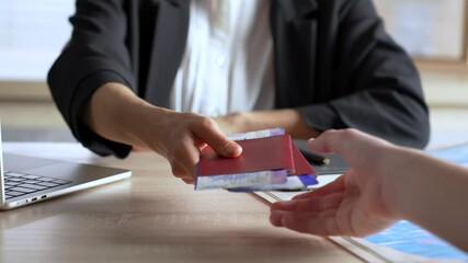 Travel agent booking a vacation tour close up. Person buying flight tickets in travel agency for summer vacation