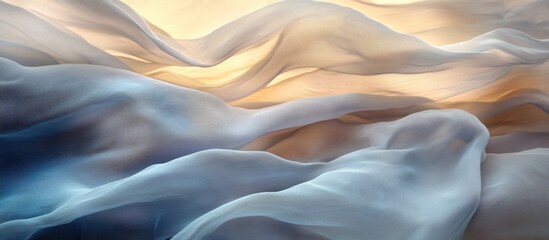 Obraz premium Abstract flowing fabric with soft blue and warm yellow hues creating a calming ethereal feel