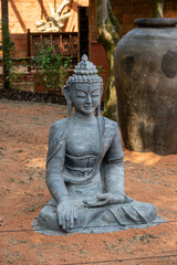 Small stone statue of Buddha. Symbol of Asian culture and religion.