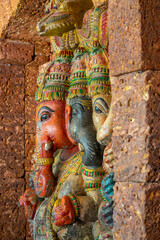 Religious decoration behind the wall in a temple. Colorful elephant statues as a symbol of East Asian culture.