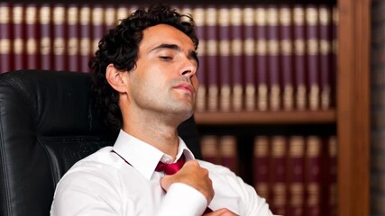 Businessman loosening his tie after a long day at work