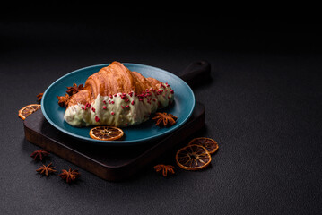 Crispy sweet red croissant with pistachio, raspberry and strawberry