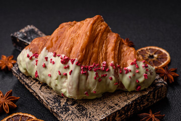 Crispy sweet red croissant with pistachio, raspberry and strawberry