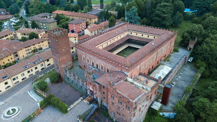 aerial view about Carimate Castle surrounded by green wild forest in sunrise lights