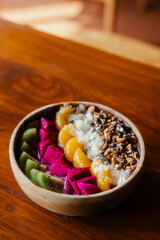 Colorful fruit bowl on wooden table