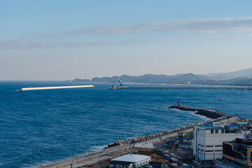 Coastal view with breakwater and bridge