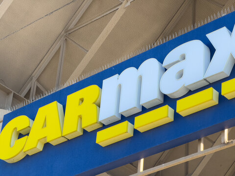 Closeup of CarMax used dealership building sign.