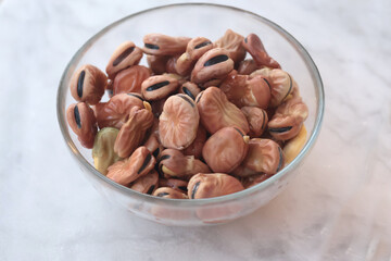 Soaked beans in water in glass bowl on marble table. Food and healthy eating. Protein foods. 