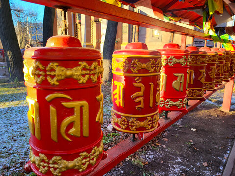 Prayer wheels in Buddhist temple. turning spinning prayer wheel at Buddhist monastery. Buddhism religion concept