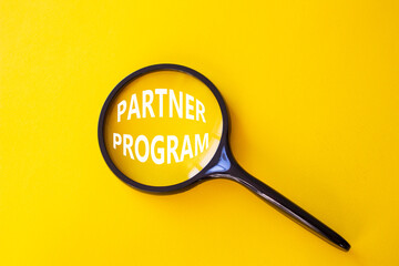 Partner Program symbol. Concept words Partner Program on magnifying glass. Beautiful yellow...