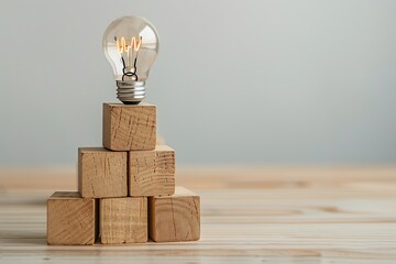 Light bulb on wooden cubes. The concept of idea and innovation.