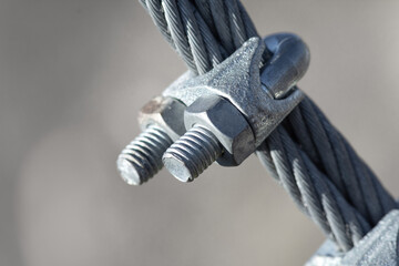 Connection and fastening of iron cables with a steel turnbuckles. Fastening elements of the cable made of galvanized steel,  clamps. Fastening system for the rope park.