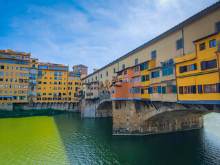 Ponte Vecchio bridge over Arno River in Florence. Picturesque medieval arched river bridge with Roman origins, lined with jewelry and souvenir shops.