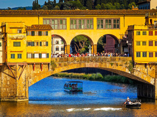 Ponte Vecchio bridge over Arno River in Florence. Picturesque medieval arched river bridge with Roman origins, lined with jewelry and souvenir shops.