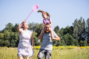 Parent and child. Happy family. Mom, dad and child relaxing in nature. Family in the park. Family...