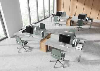 Modern coworking office interior with glass desks and green chairs in a bright open space with large windows and natural city view. 3D Rendering