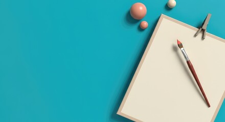 Artistic workspace with canvas, paintbrush, and geometric shapes on blue background