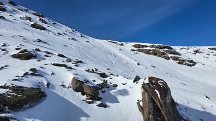 Snowy hillside with large rock formations