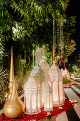 Illuminated lanterns and decorative accents create a magical outdoor pathway at night.