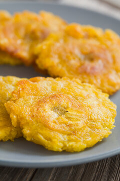 Tostones or patacones, crispy fried plantain slices a typical and traditional Latin American snack and accompaniment (Selective Focus, Focus through the middle of the first slice)