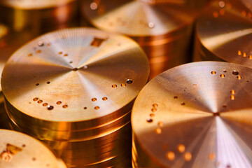 Intricate watch mechanism bases showcasing refined metalworking craftsmanship in a vibrant workshop...