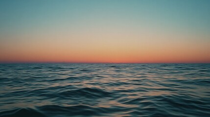 Fototapeta premium The vast ocean stretches under a vibrant gradient of pastel hues, capturing a serene sunset's gentle calm and infinite possibilities.