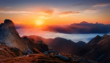 Fototapeta premium A breathtaking mountain landscape at sunrise, with mist rolling over the peaks, bathed in soft golden light, creating a serene and awe-inspiring view.