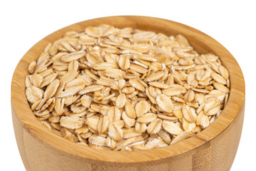 Close-up of rolled oats in a bamboo bowl, emphasizing healthy, natural, and organic ingredients. Perfect for breakfast, cooking, or as a nutritious addition to a balanced diet.