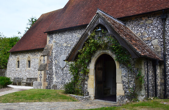 Entrance of the St. Simon and St. Jude Church covered in ivy. East Dean, Wealden District, East Sussex, UK